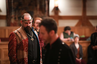 Production photo of Henry glaring at a blurry Worcester at the front of image.